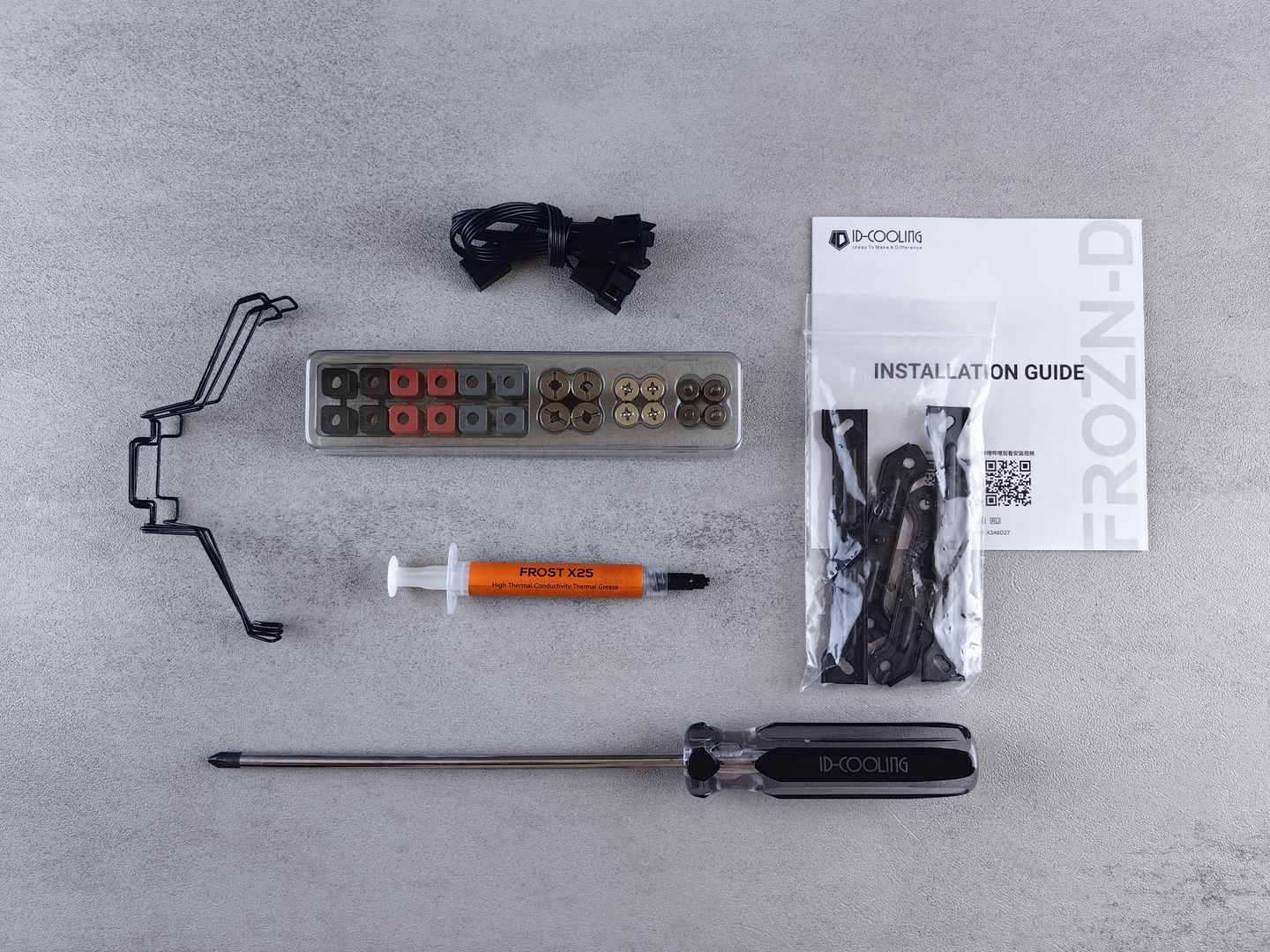 Flat lay of computer cooling hardware kit with installation guide and tools.